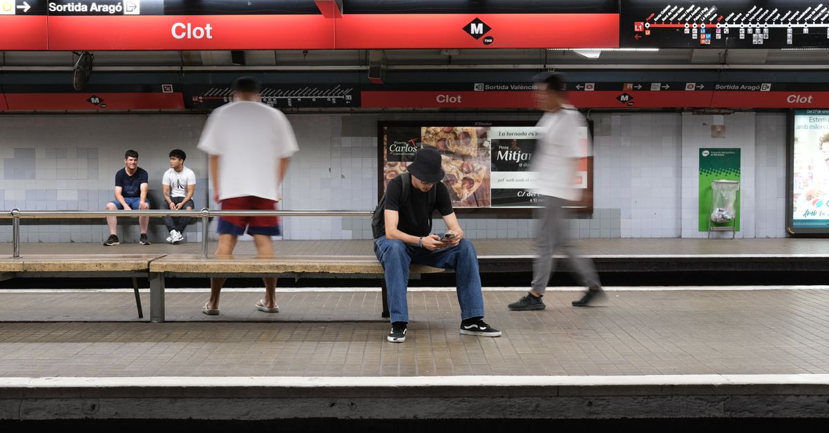Candid scene of commuters at Clot Metro Station in Barcelona, capturing urban life dynamics.